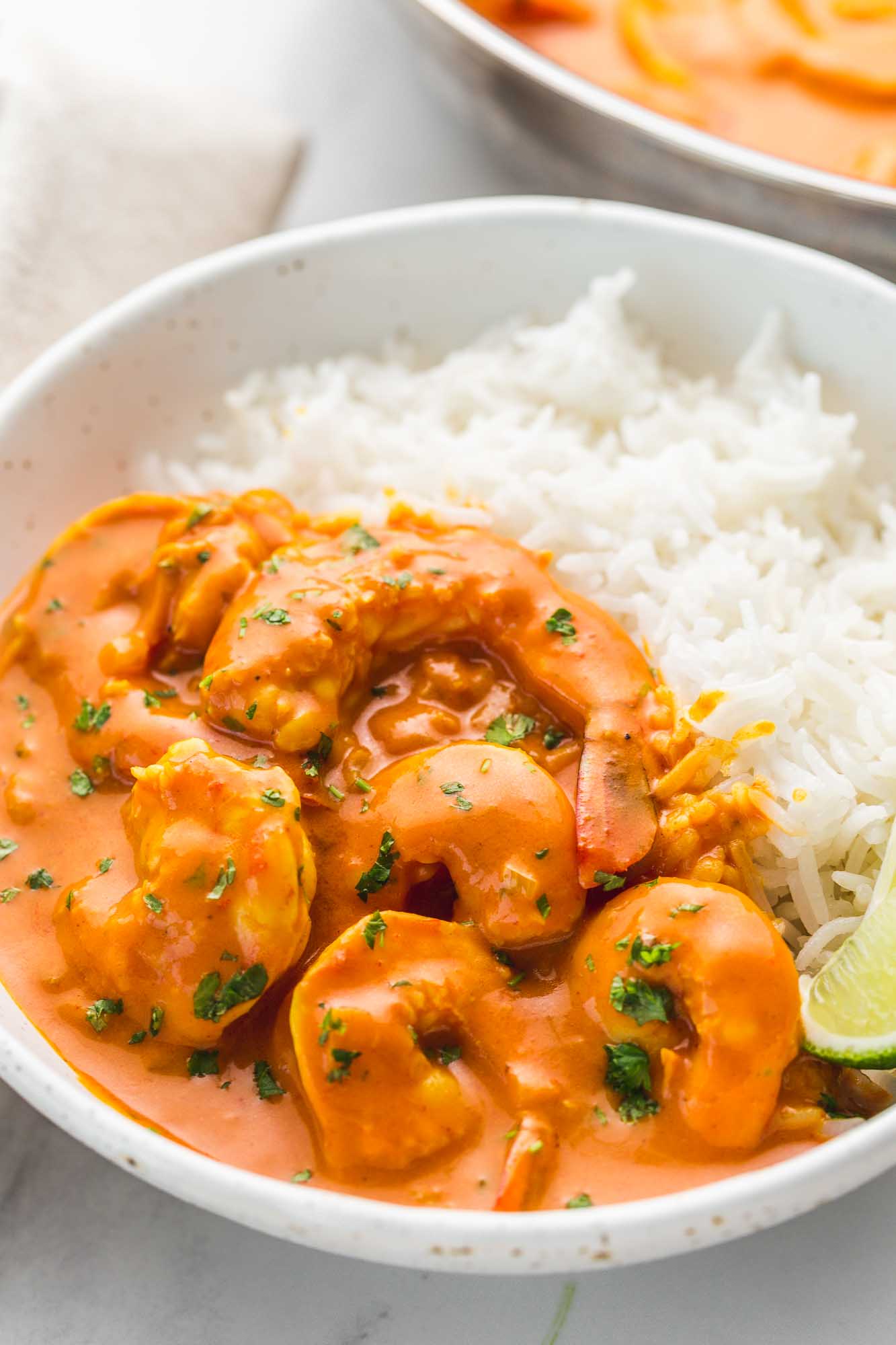 Coconut shrimp curry served in a white bowl with white rice