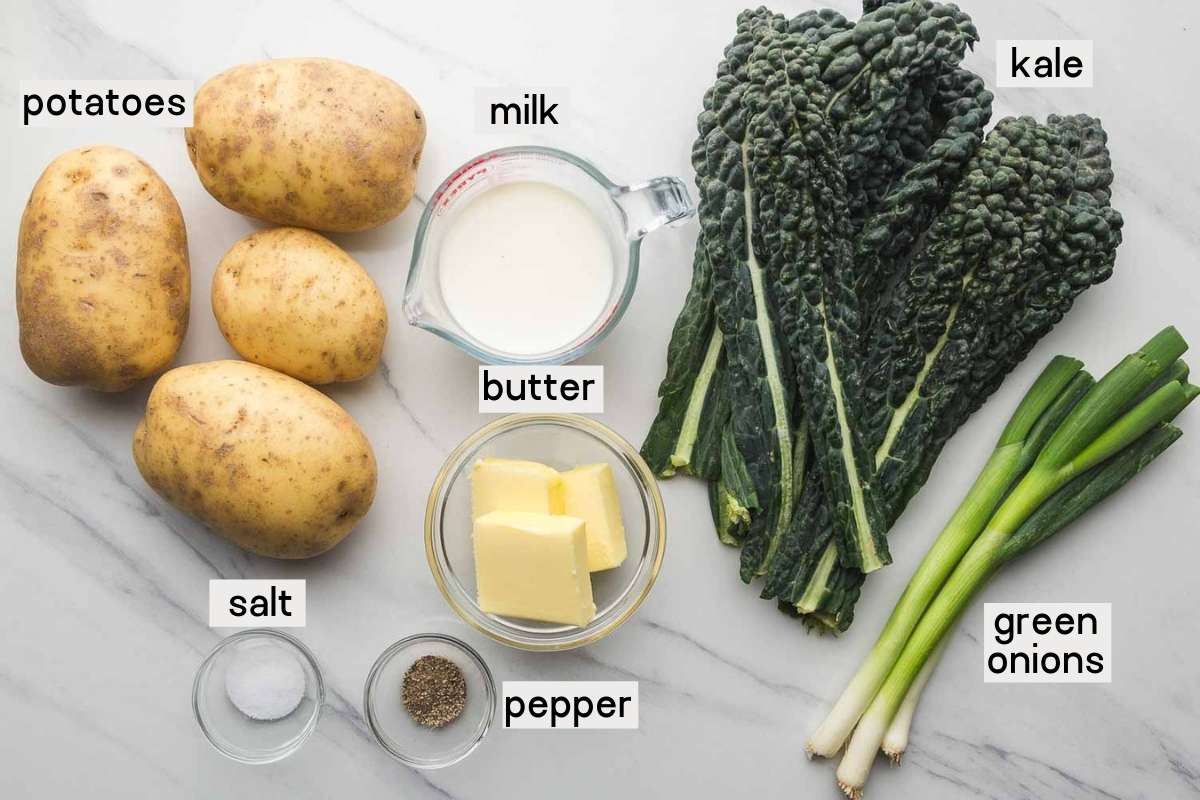 Ingredients needed to make colcannon, potatoes, kale, green onions, milk, butter, salt and pepper.