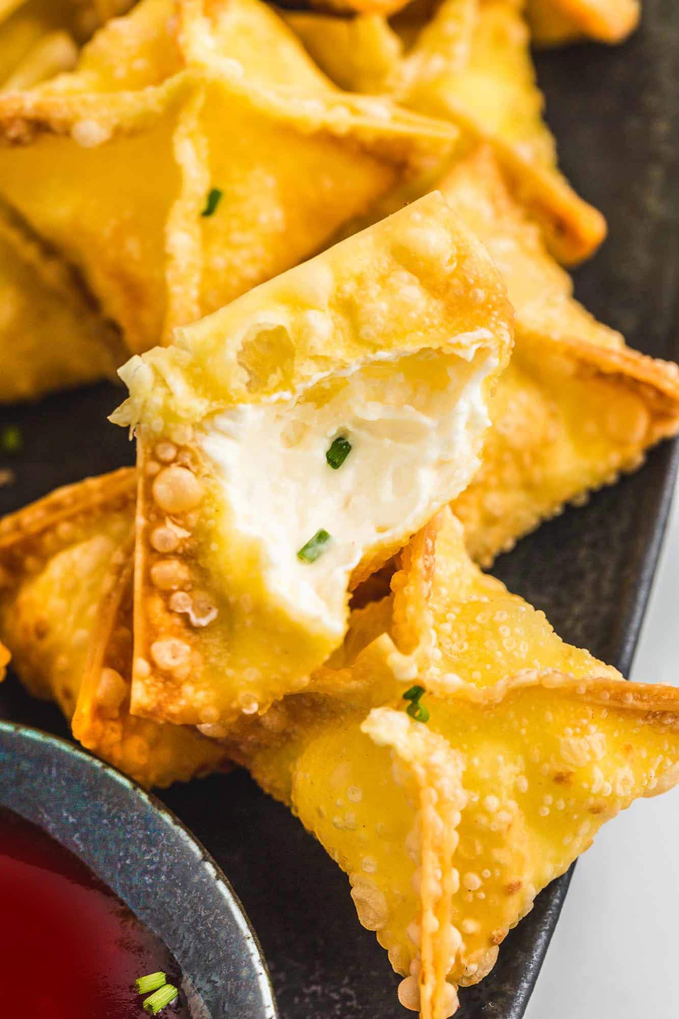 Cream cheese rangoons from the inside filled with soft cream cheese and chives