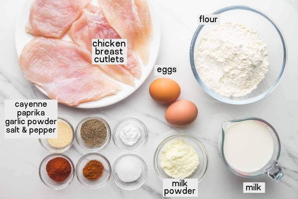 Ingredients needed to make Chick-Fil-A Sandwich including chicken cutlets, flour, eggs, milk, milk powder, and seasonings