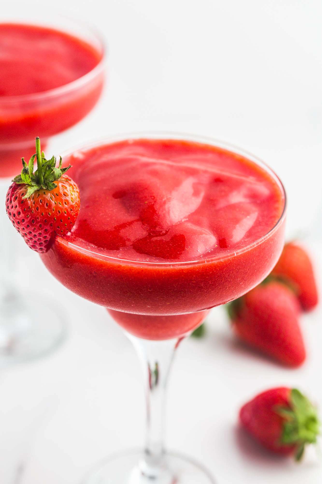Strawberry Daiquiri in martini glasses, garnished with fresh strawberries