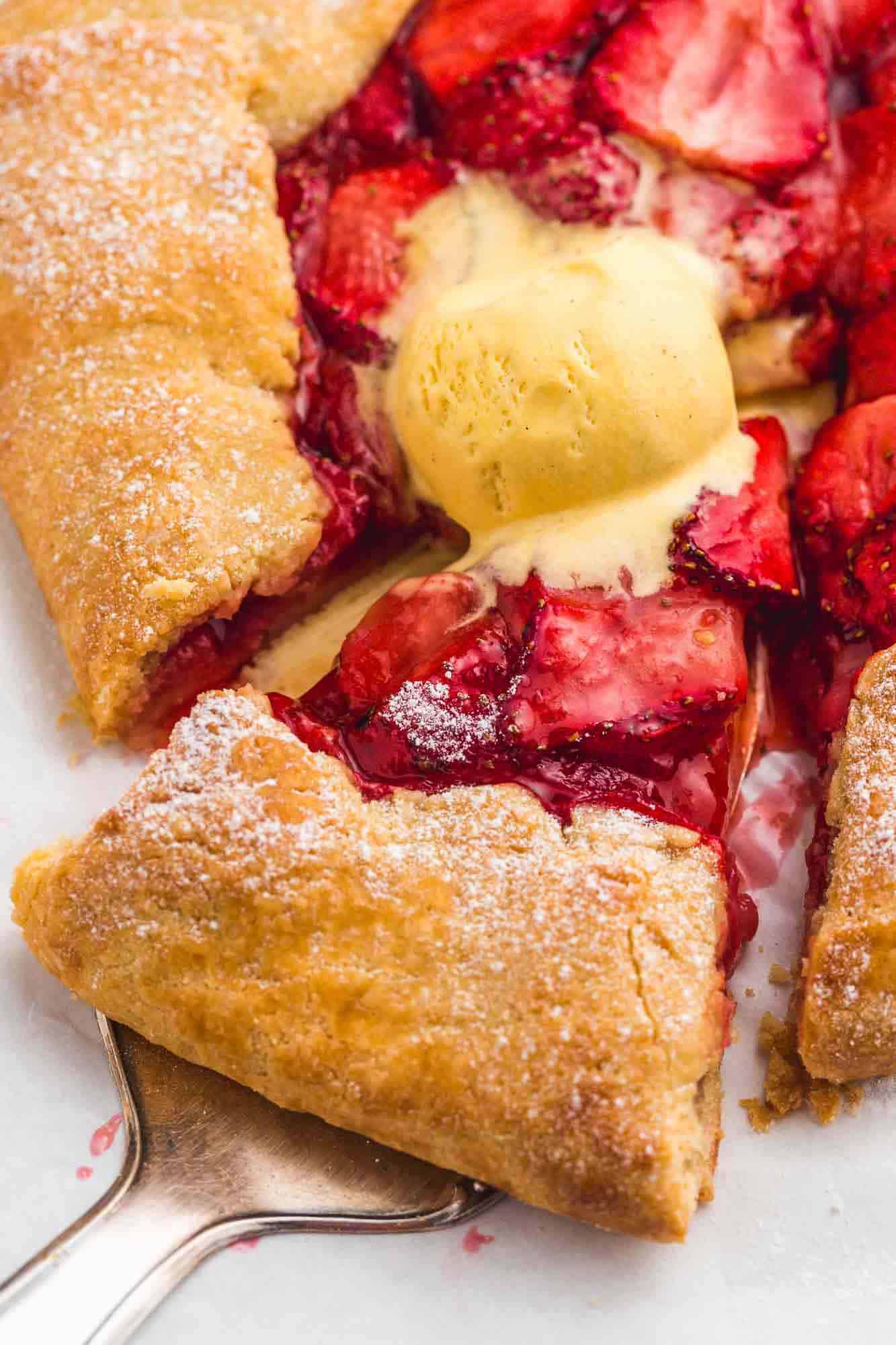 Overhead shot of a sliced strawberry galette sprinkled with powdered sugar