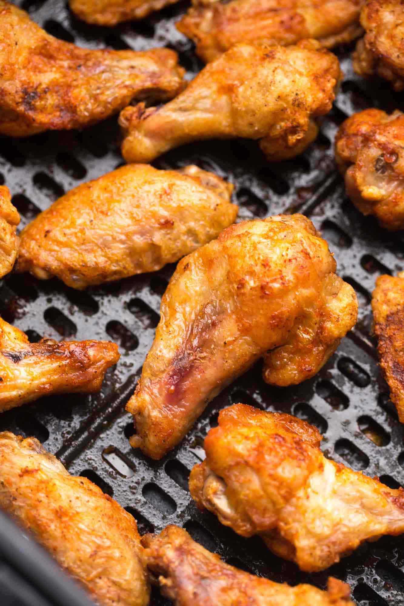 Air Fried chicken wings in a Cosori air fryer basket