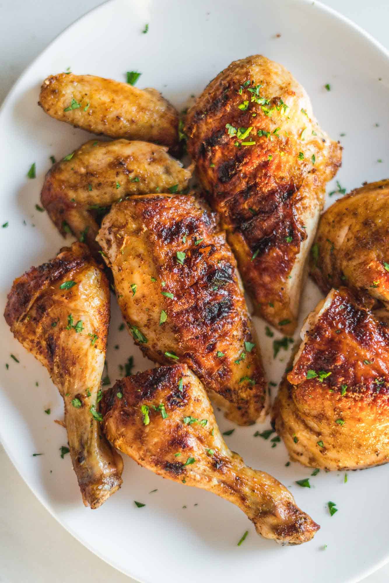 Grilled chicken carved and placed on a white platter