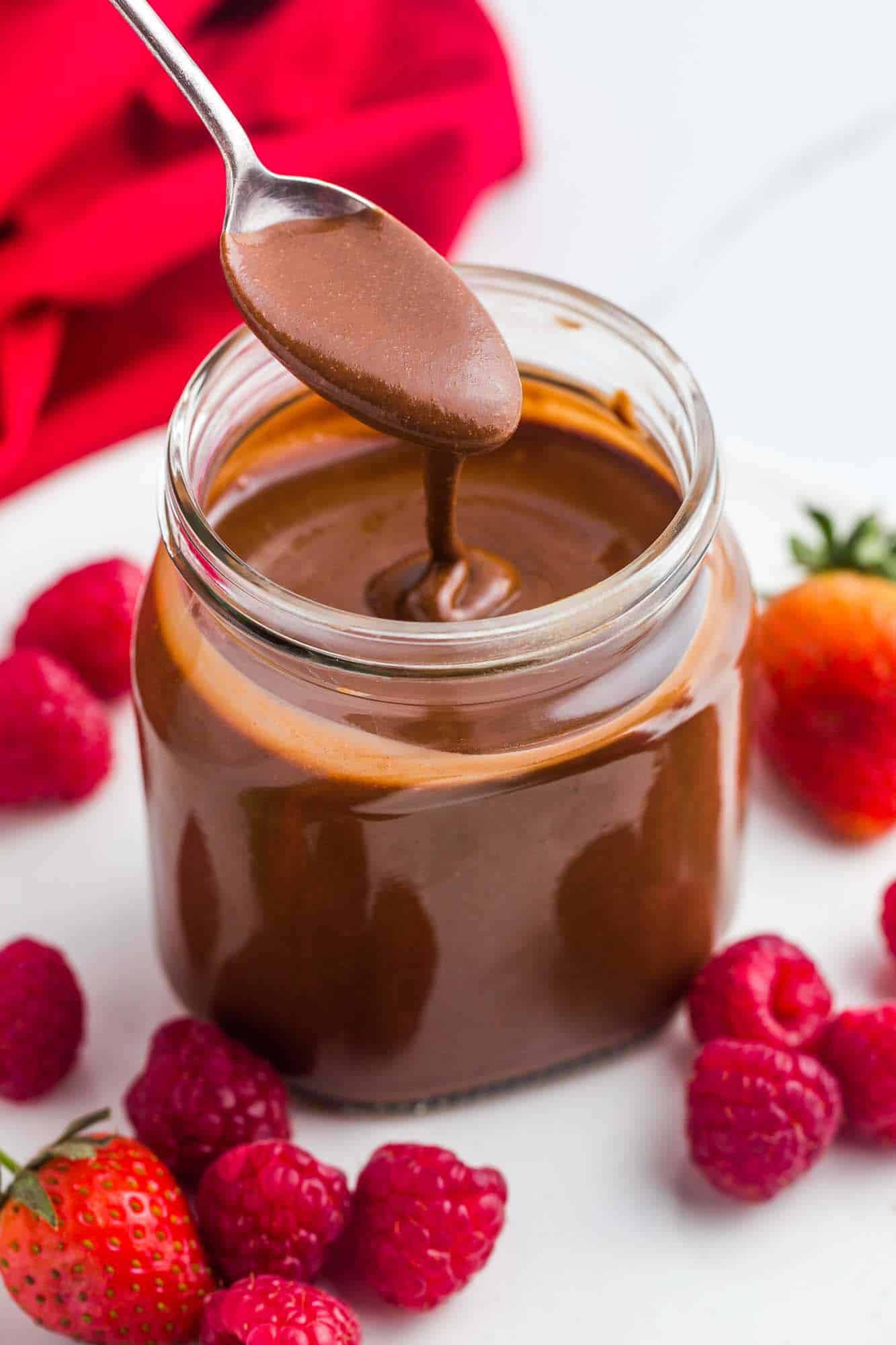 Homemade Nutella with a spoon and fresh berries