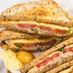 Stacked tuna melt sandwiches with potato chips