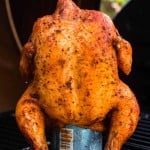 Grilled beer can chicken on an outdoor grill
