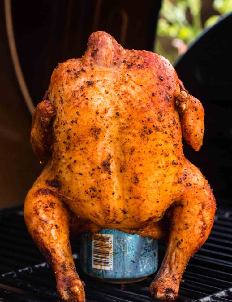 Grilled beer can chicken on an outdoor grill