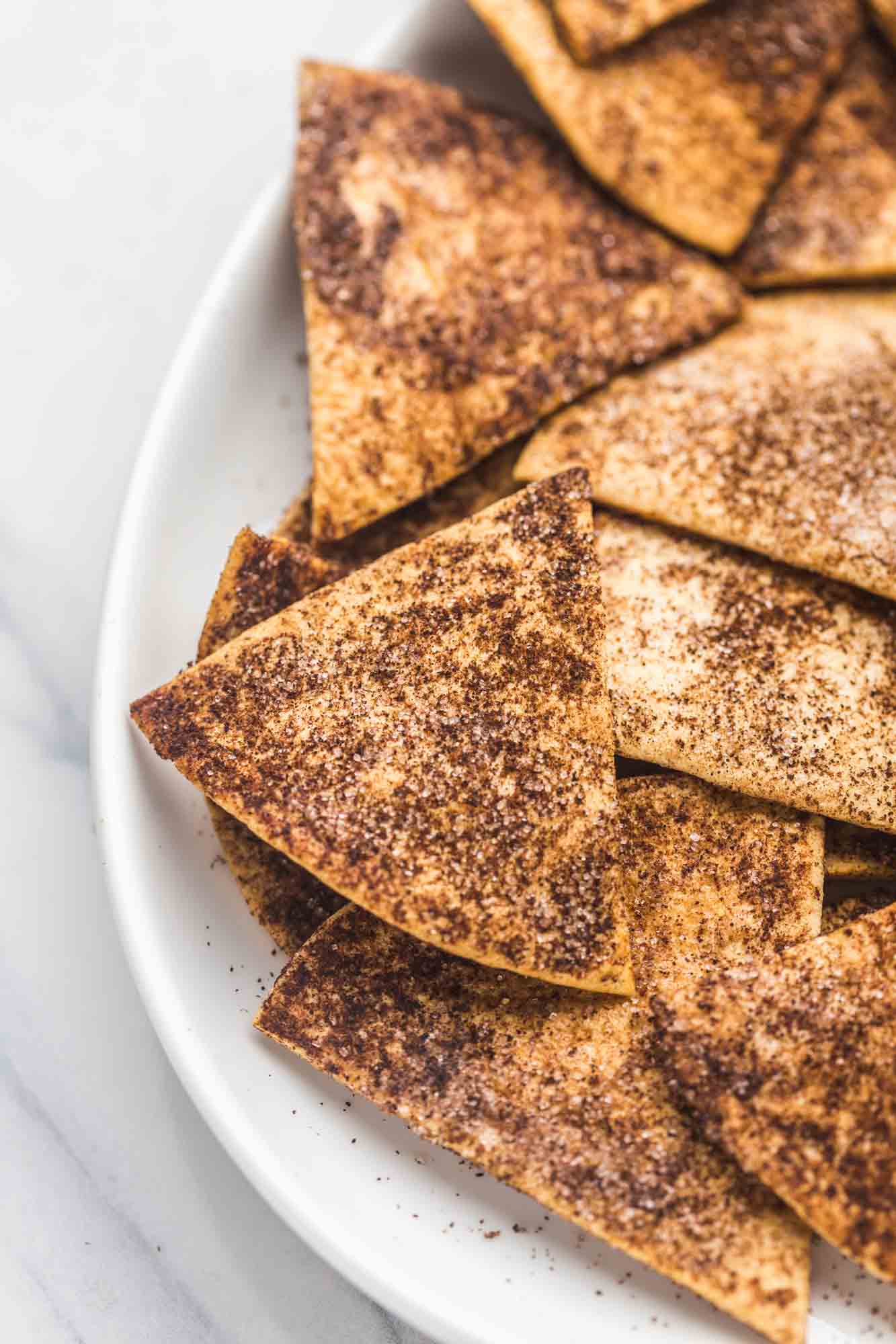 Close up shot of cinnamon chips on a white plate