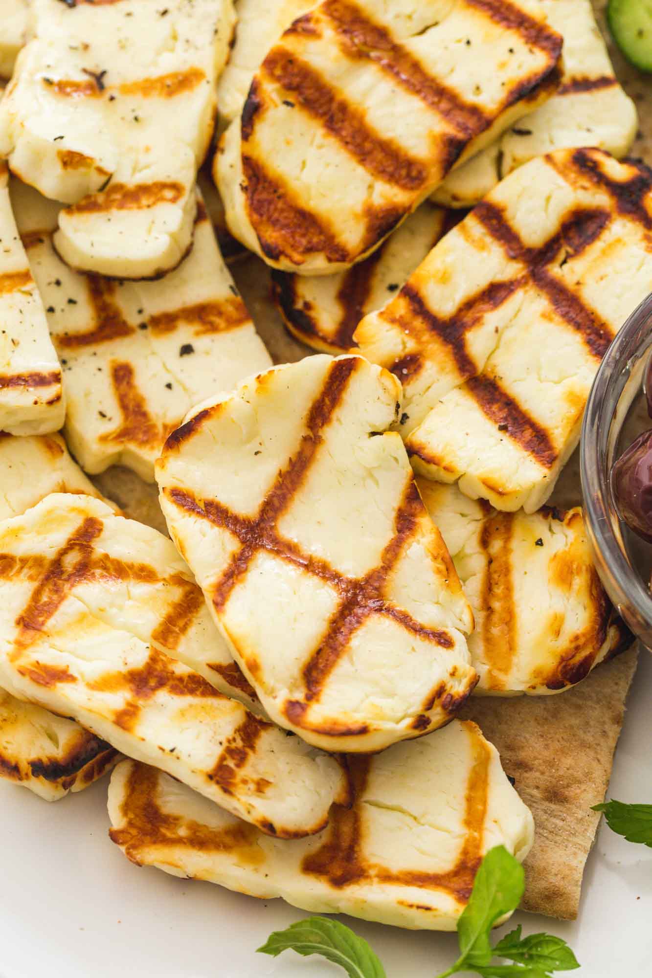 Close up of grilled halloumi slices on a platter