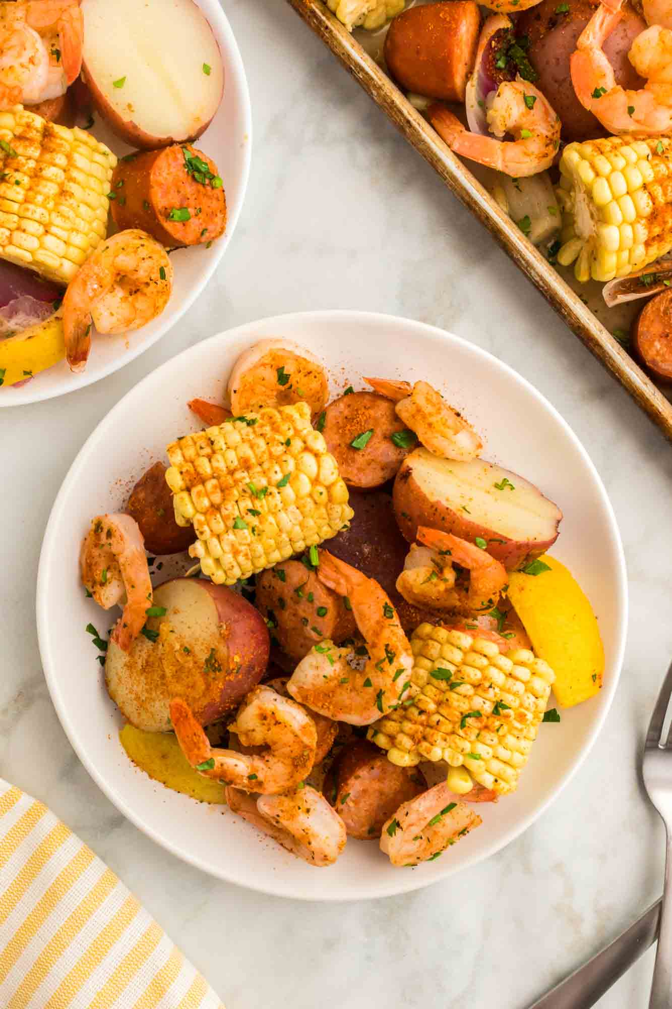 Shrimp boil served on white plates for individual servings