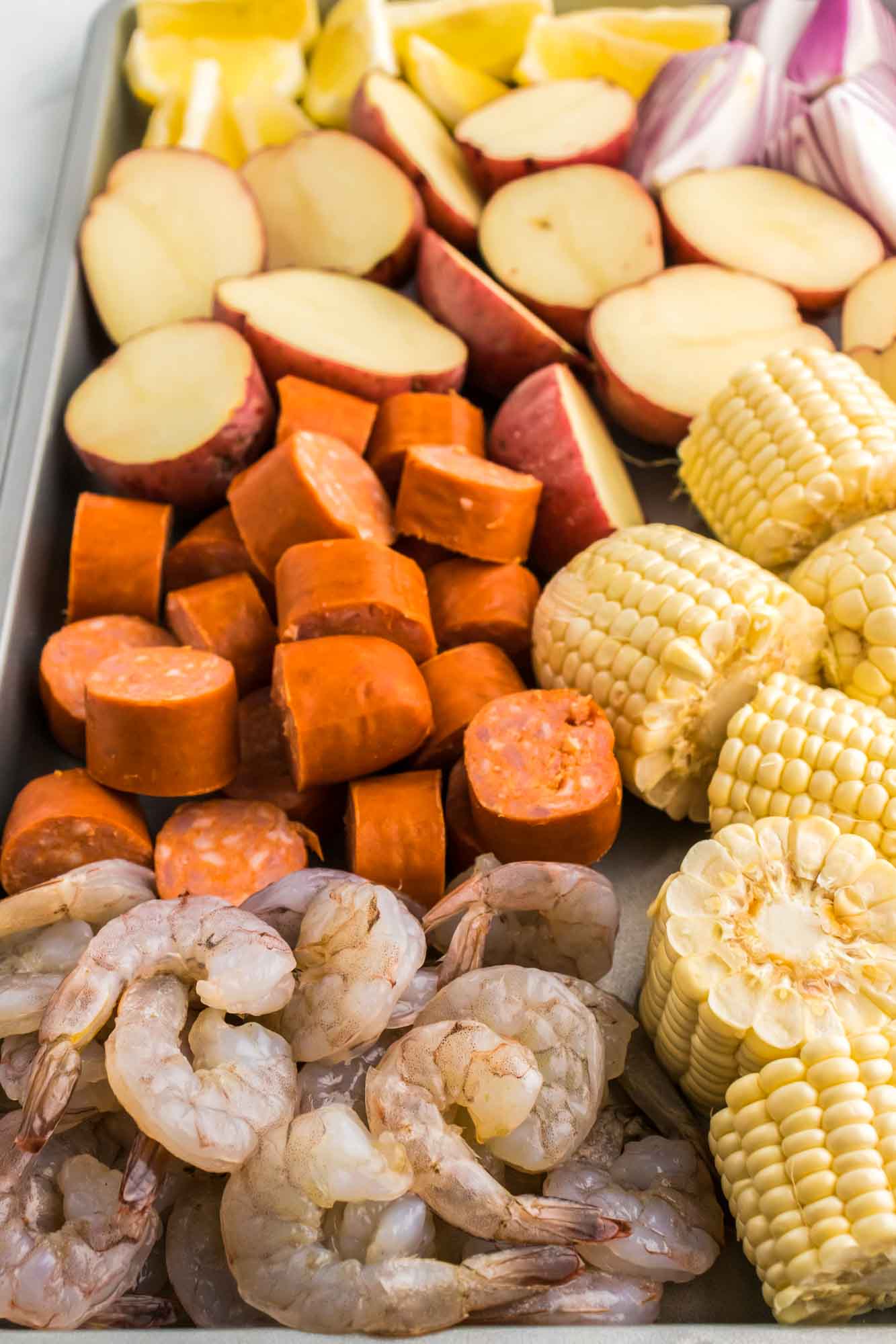 Shrimp Boil Prepped Ingredients on a Sheet Pan