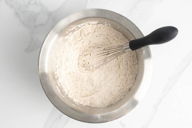 Dry ingredients mixed in a bowl with a whisk
