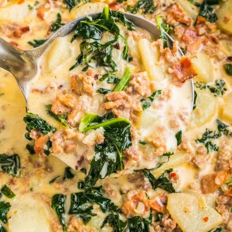 Zuppa Toscana in a cast iron pot with a soup ladle