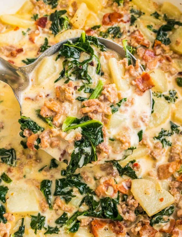 Zuppa Toscana in a cast iron pot with a soup ladle