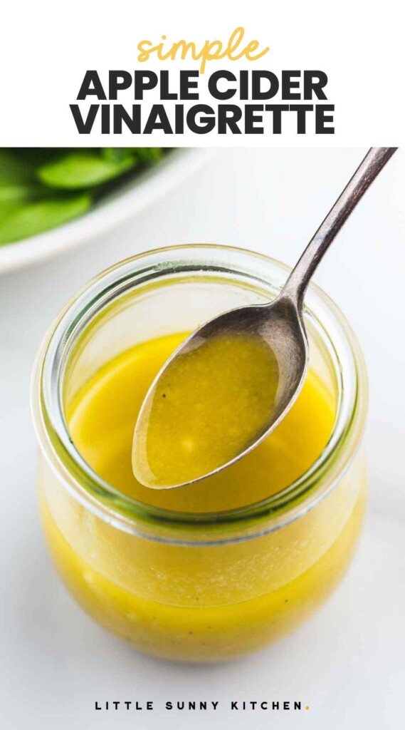 Apple Cider Vinaigrette in a small Weck jar and a spoon, with overlay text "simple apple cider vinaigrette"