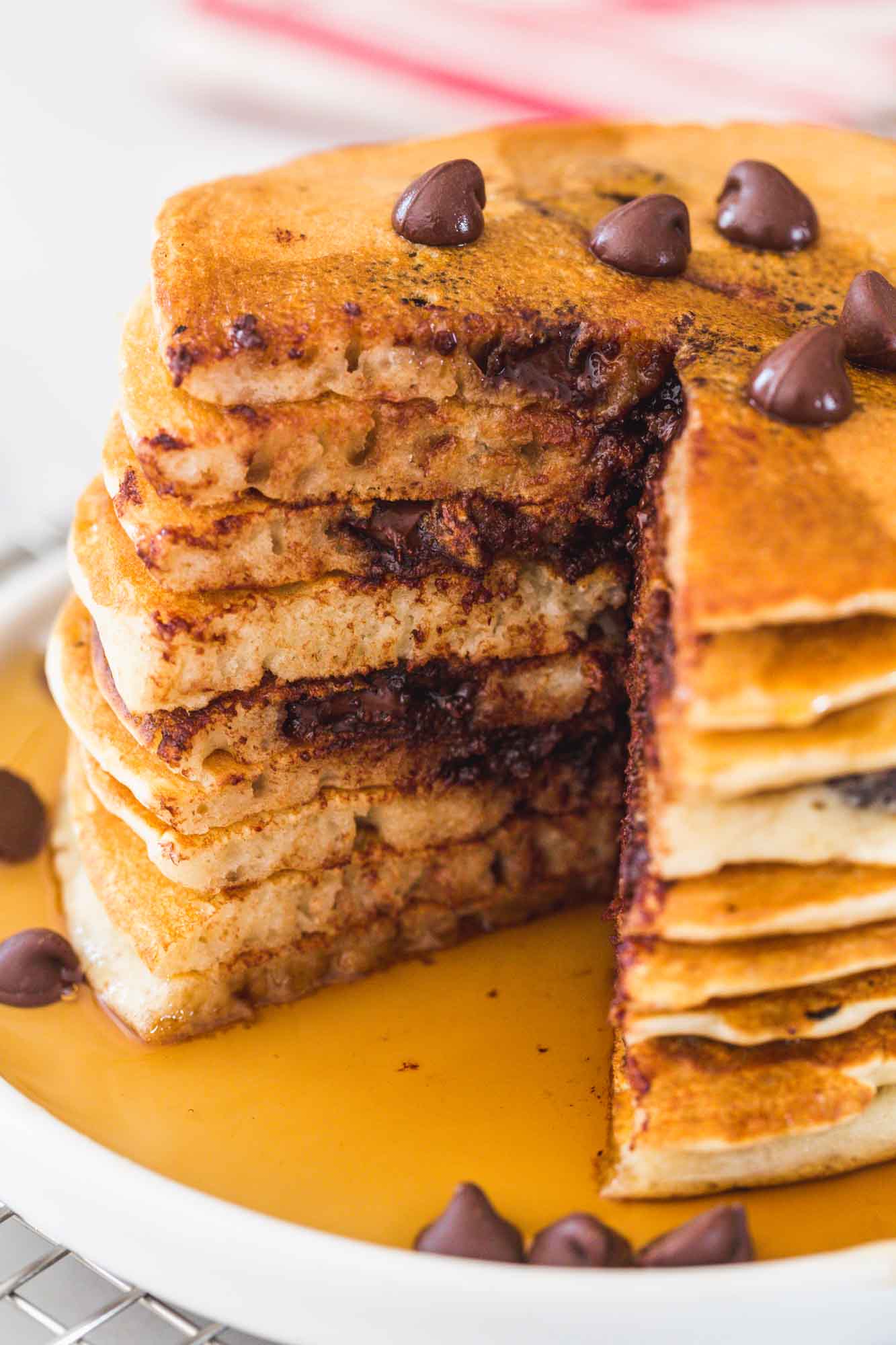 Stack of chocolate chip pancakes being cut through