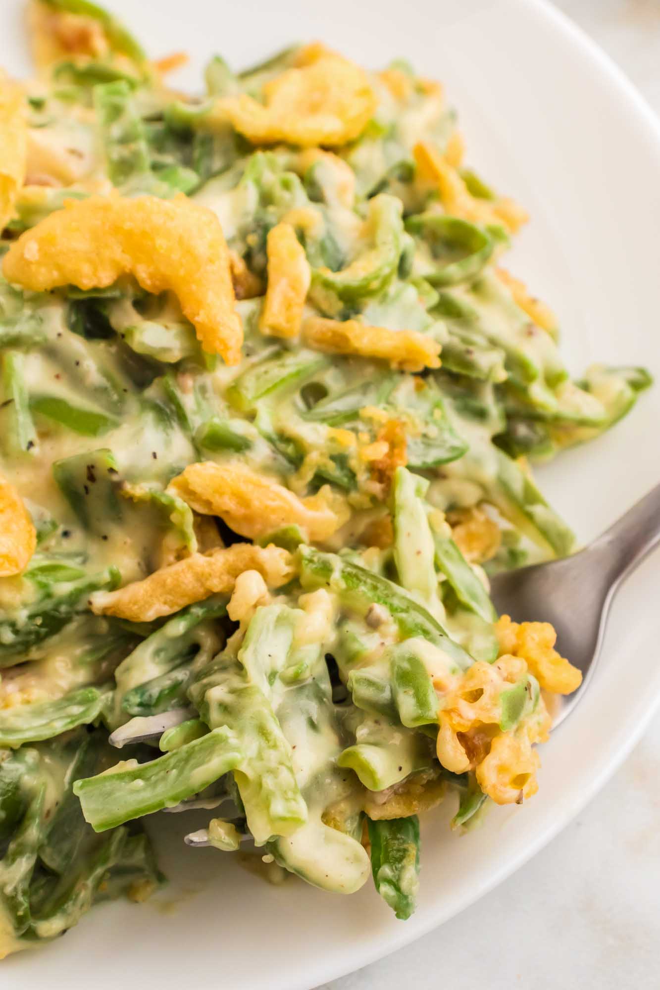 Close up shot of served green bean casserole and a fork