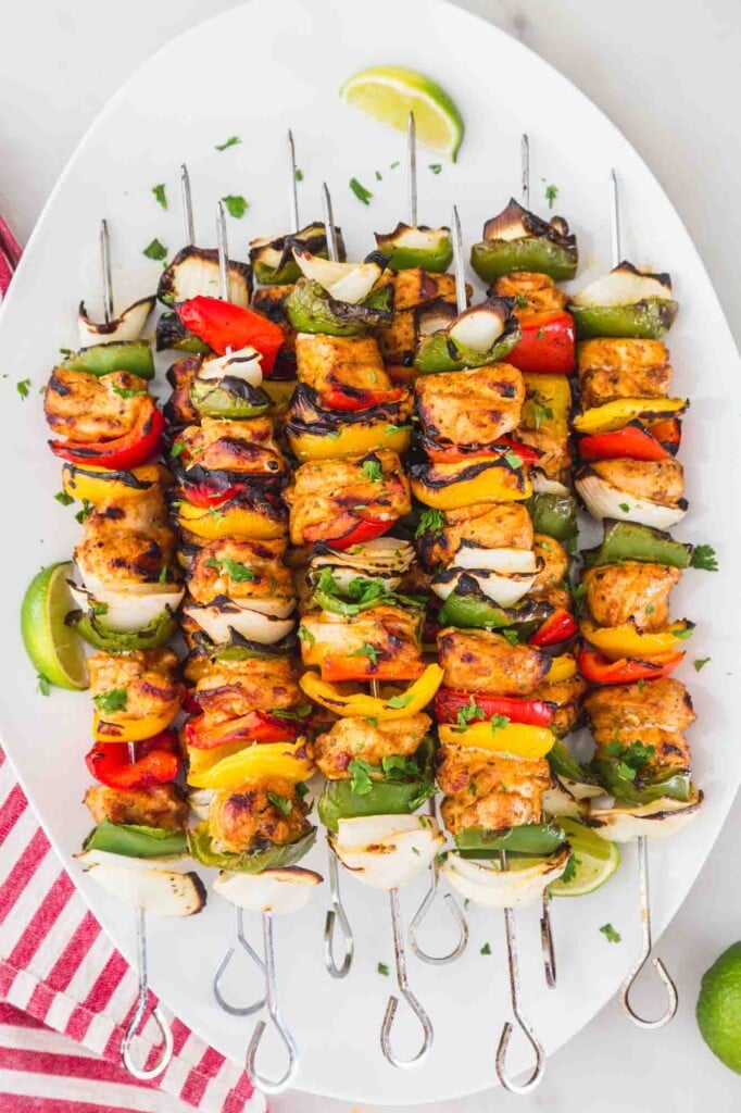 Fajita chicken kebabs served on a large white platter
