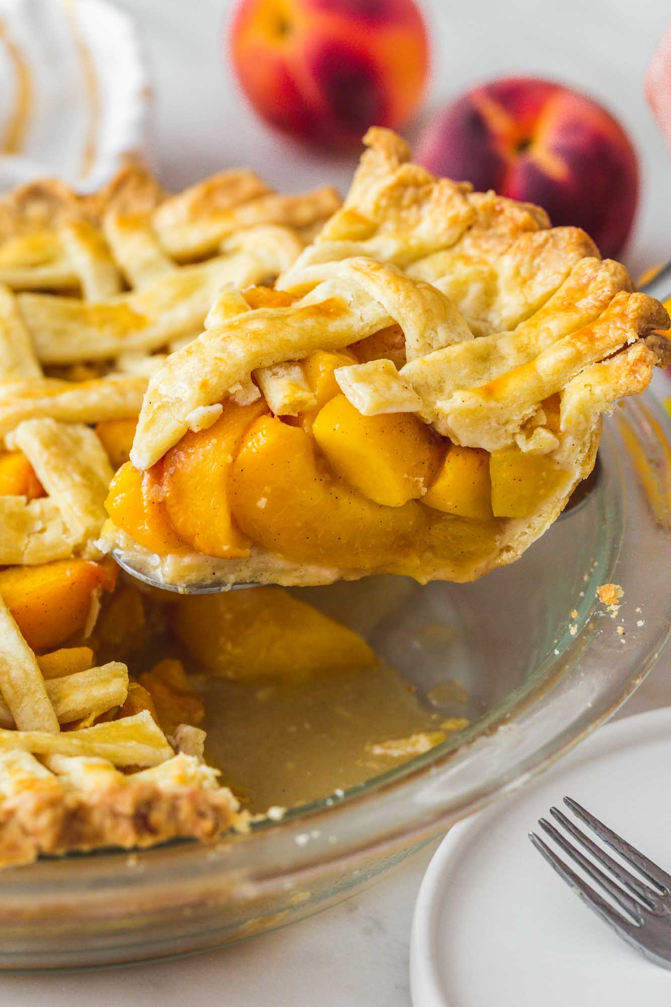 Taking a slice of peach pie from the pie dish