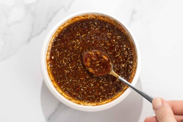 Peruvian chicken marinade mixed up in a bowl with a spoon