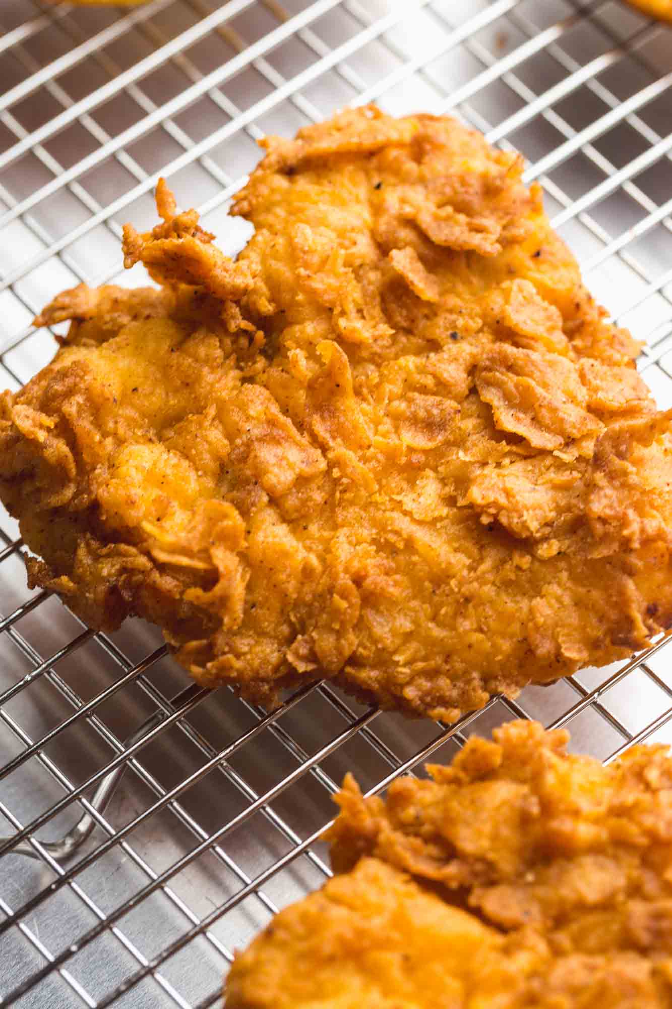 Crispy and flaky fried chicken on a wire rack