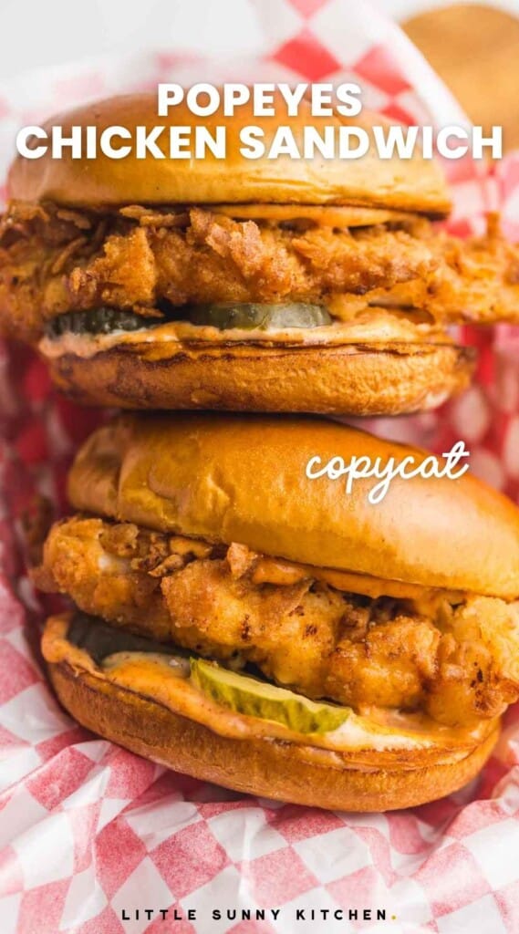 Overhead shot of two popeyes chicken sandwiches in a serving basket with paper, and overlay text that reads "popeyes chicken sandwich, copycat"