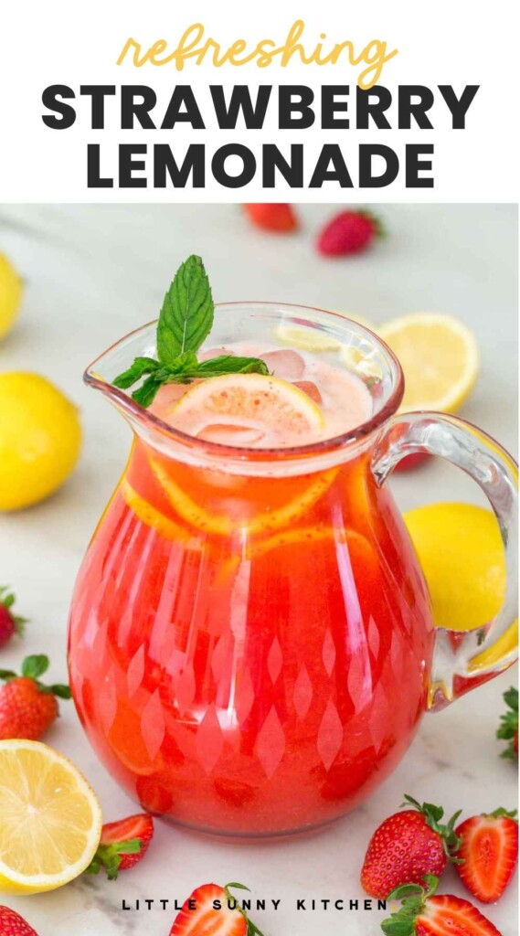 Strawberry lemonade in a large glass pitcher, garnished with lemon slices and mint leaves. And overlay text "refreshing strawberry lemonade"