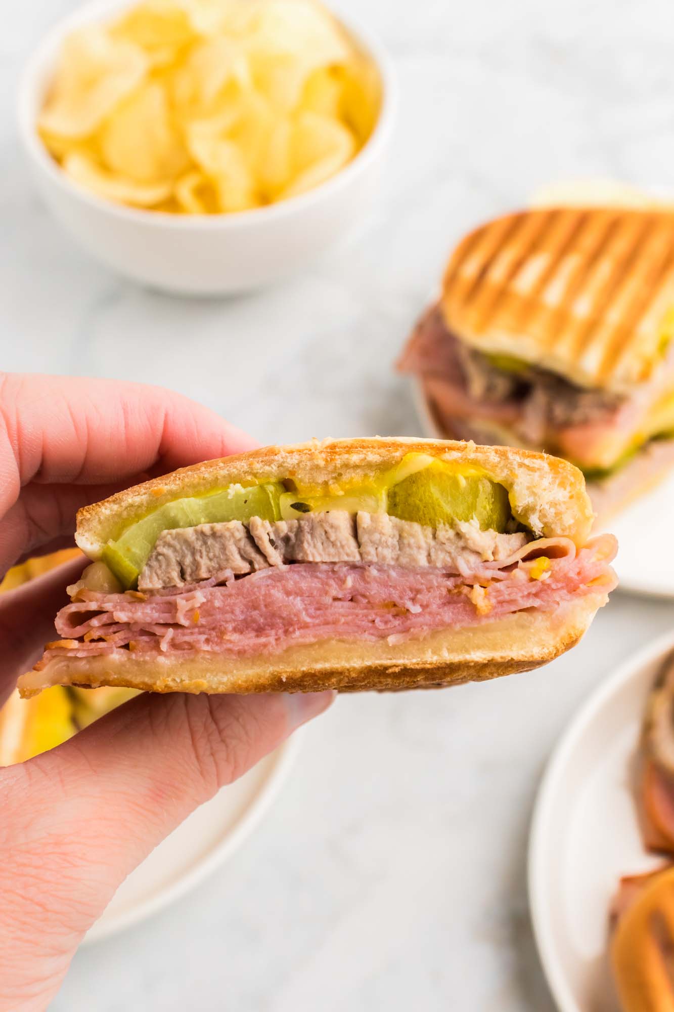 Holding a Cuban sandwich to show the layers
