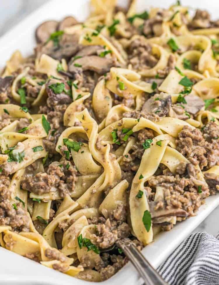Ground beef stroganoff with egg noodles served in a white casserole dish