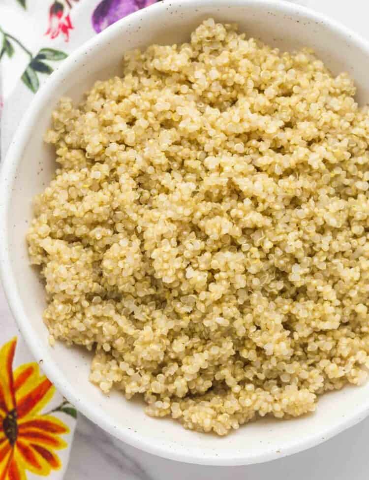 Overhead shot of a perfectly cooked quinoa in a white bowl