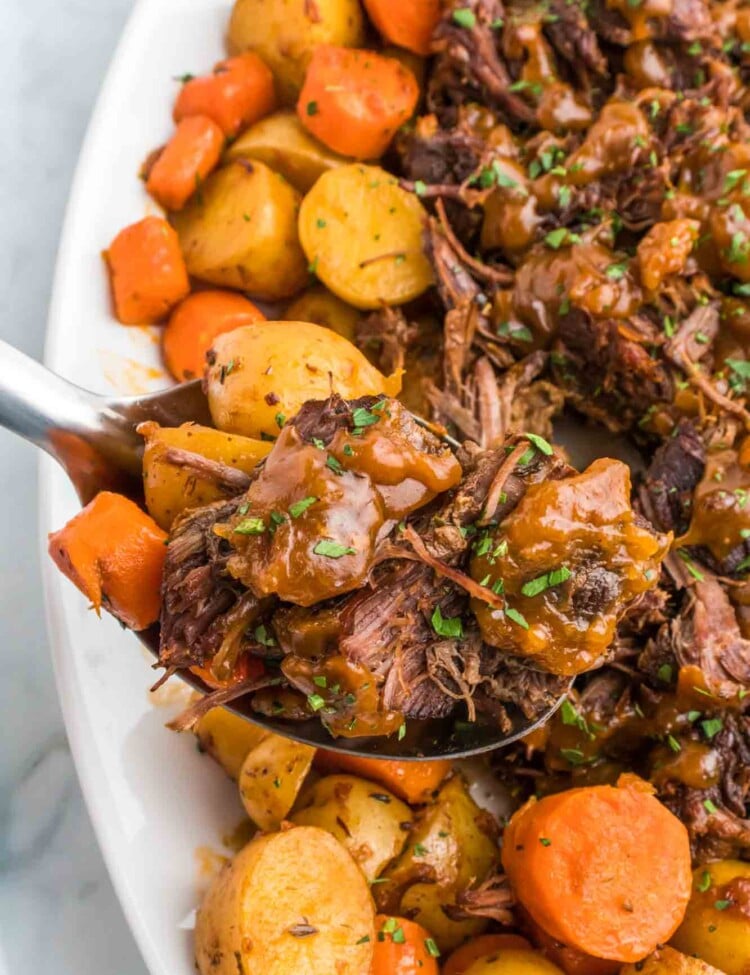 Serving pot roast with a serving spoon