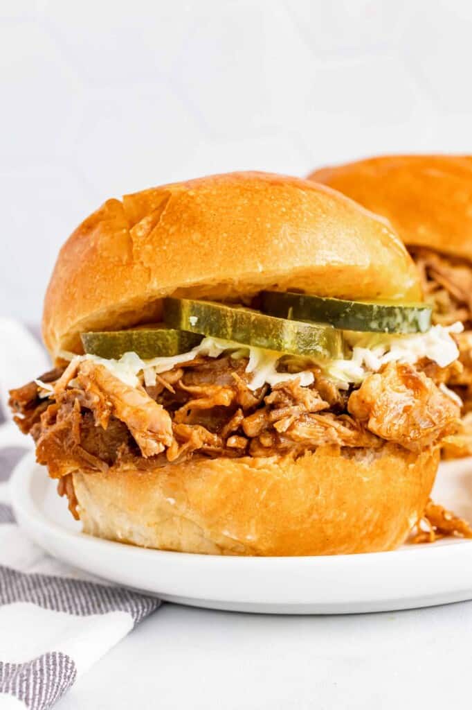 Pulled pork in a slider with slaw and pickles