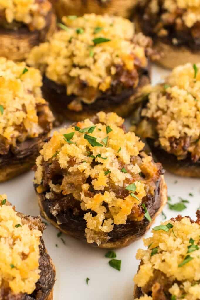 Sausage stuffed mushrooms served on a white plate