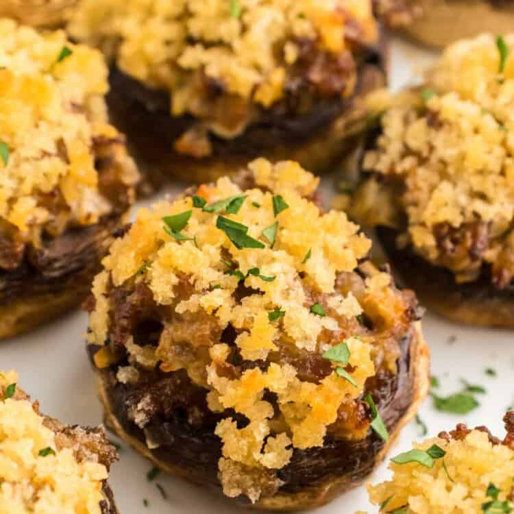 Sausage stuffed mushrooms served on a white plate
