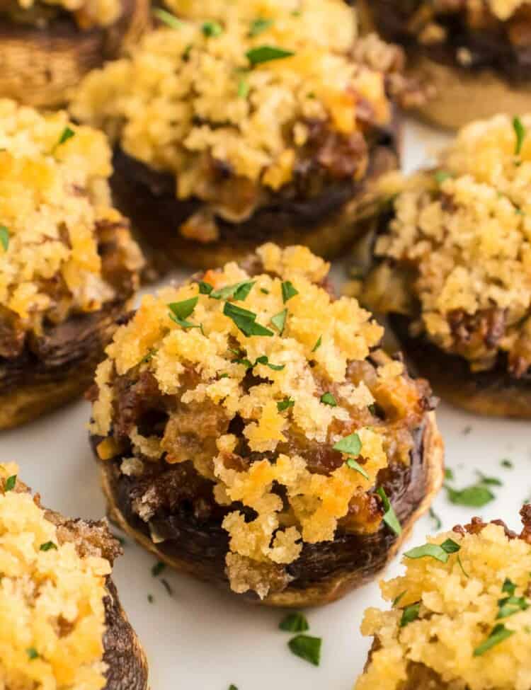 Sausage stuffed mushrooms served on a white plate