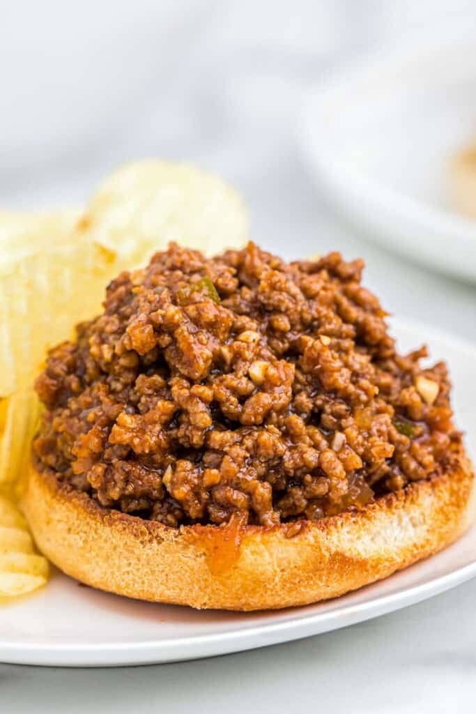 Sloppy joe on a half bun served with chips