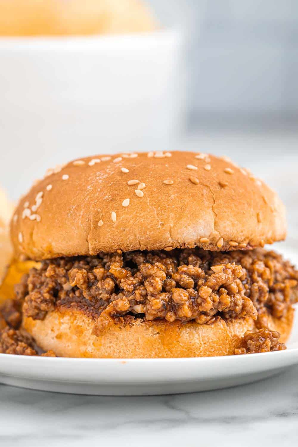 Sloppy joes roll on a white plate