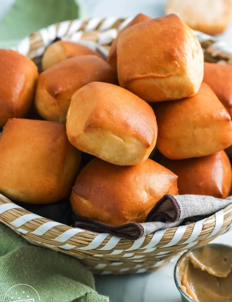 Texas roadhouse rolls stacked in a bread basket