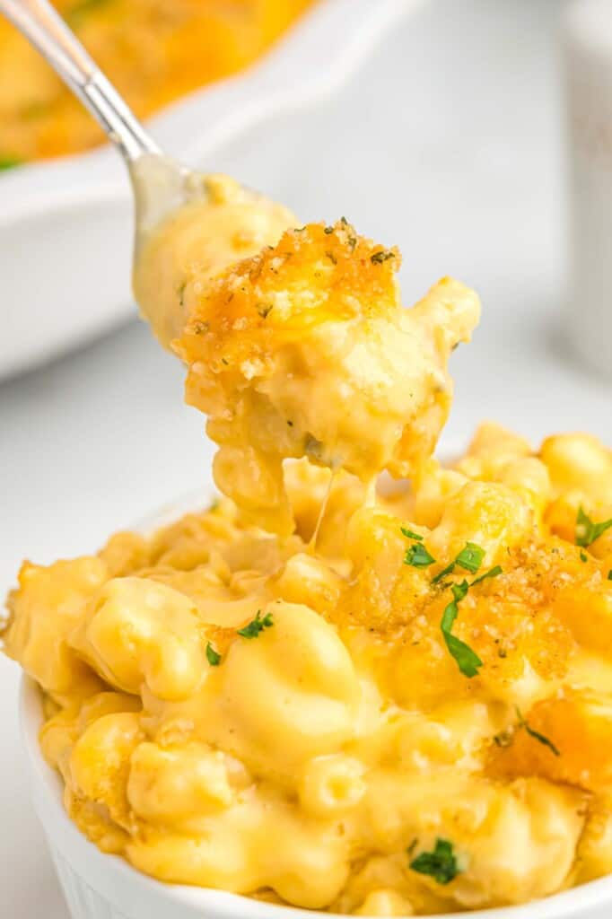 Velveeta mac and cheese served in a white bowl, eating from it with a fork