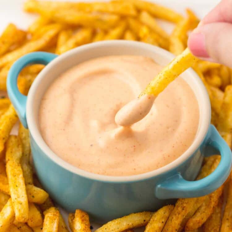 Dipping fresh fries in fry sauce that's served in a blue dish