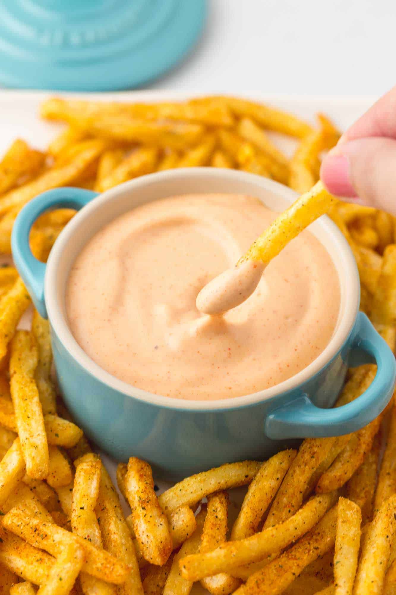 Dipping fresh fries in fry sauce that's served in a blue dish