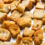 Close up shot of homemade toasted croutons on a baking sheet