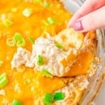 Dipping hot crab dip with a cracker