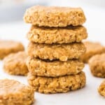 A stack of no bake peanut butter cookies on a white board