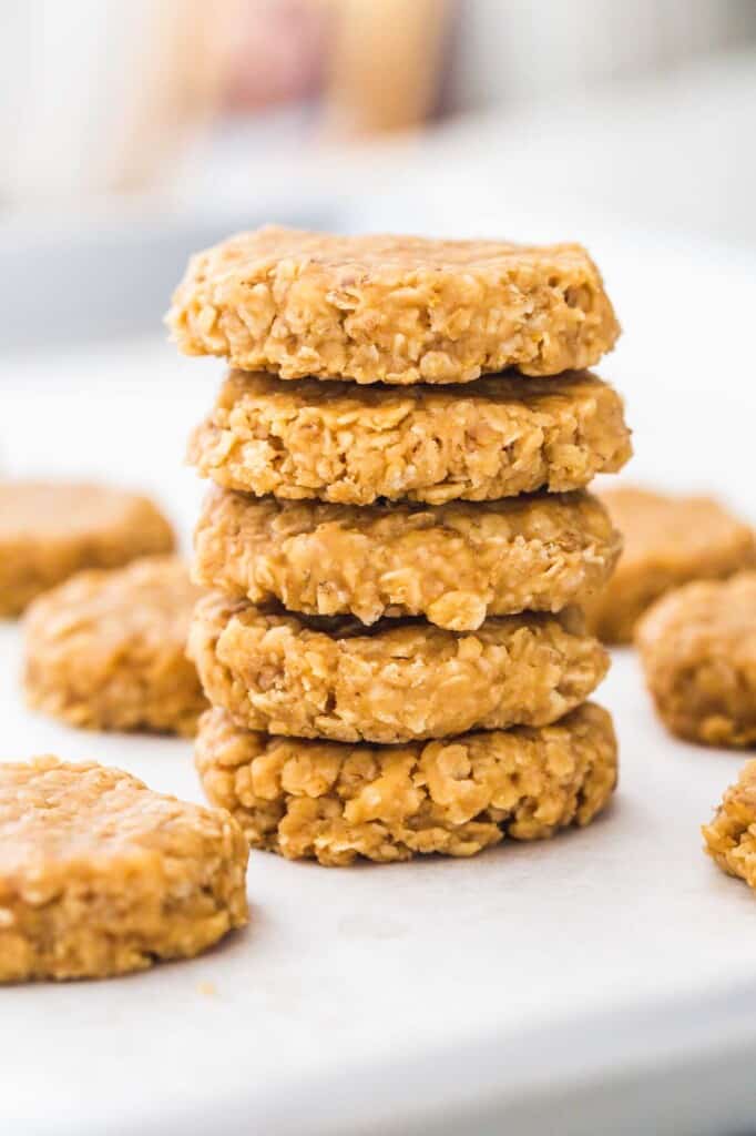A stack of no bake peanut butter cookies on a white board