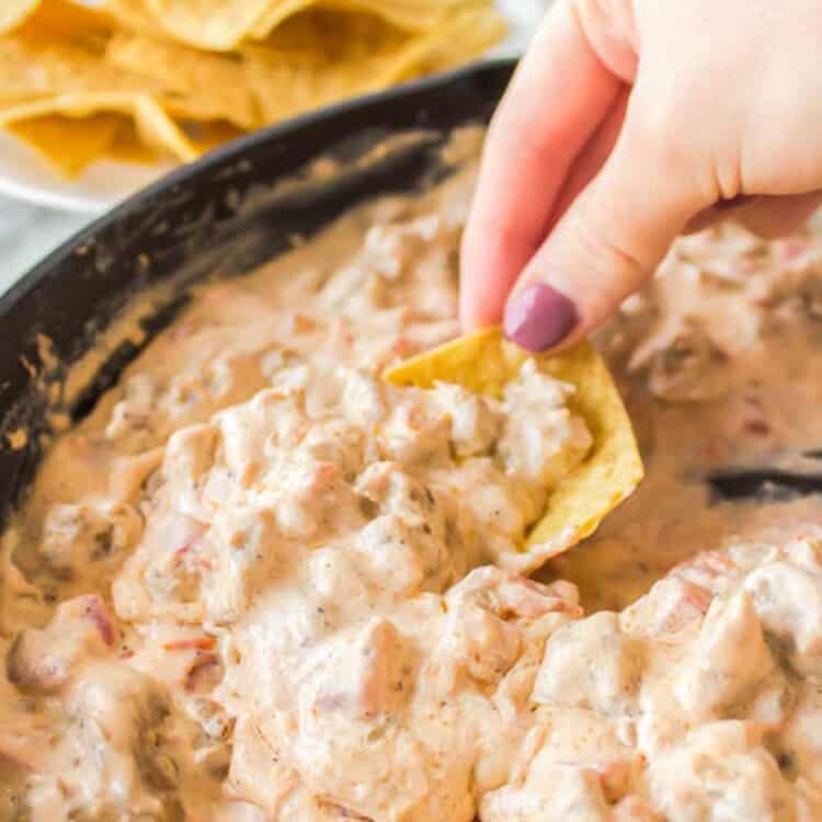 Dipping into sausage dip with a chip