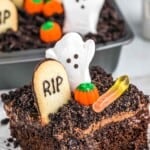 A slice of halloween dirt cake served on a square white plate