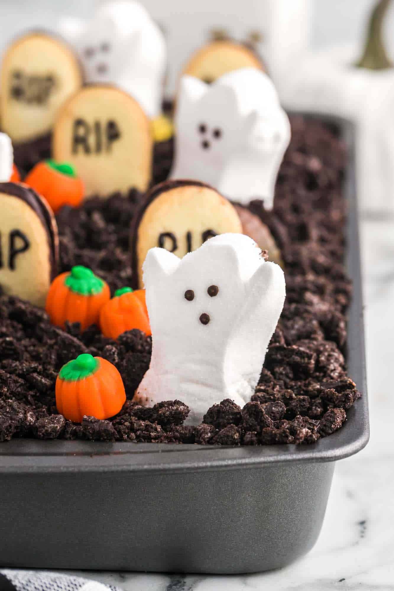 Ghost peeps and candy pumpkins on the dirt cake