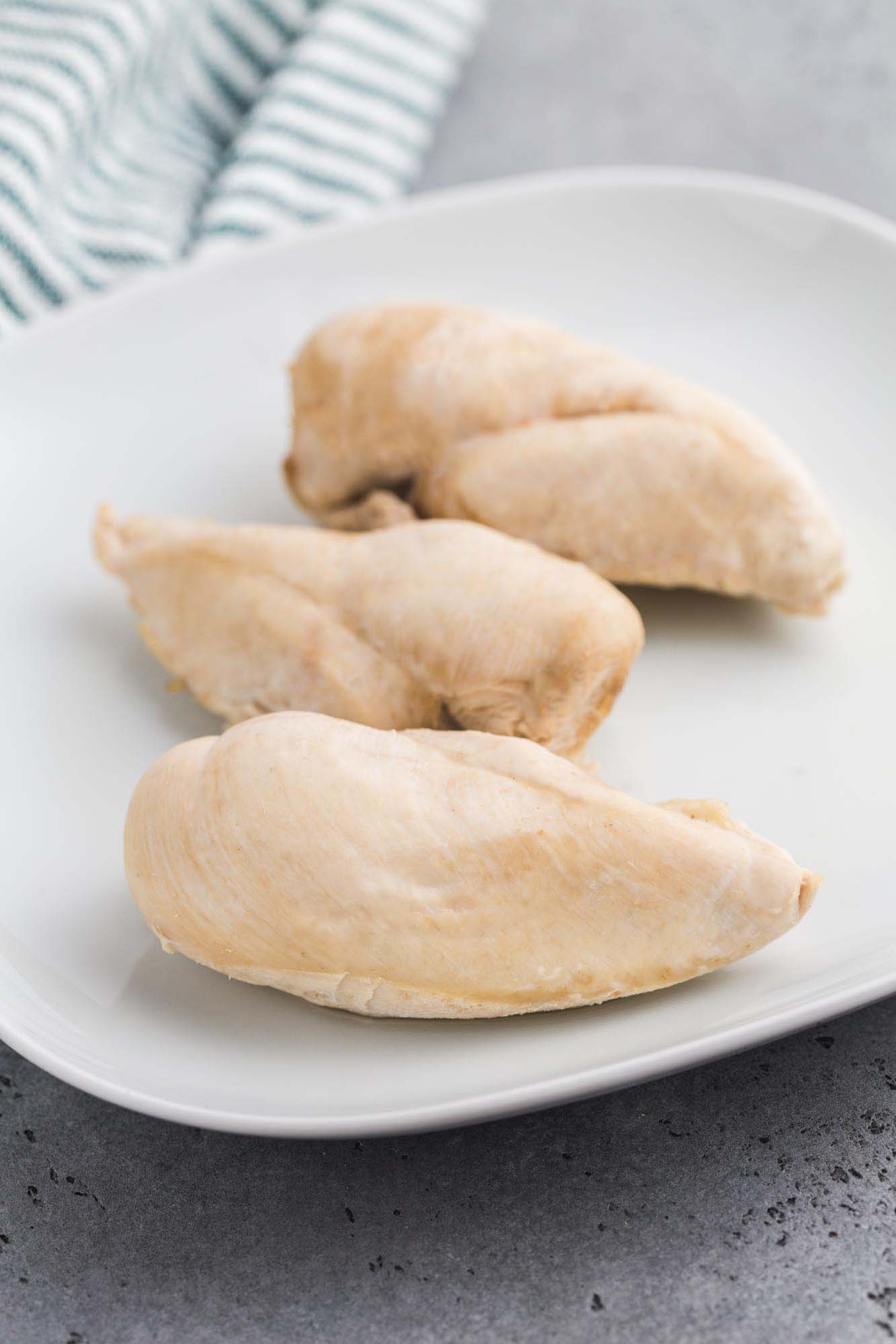 Boiled chicken breasts on a white plate